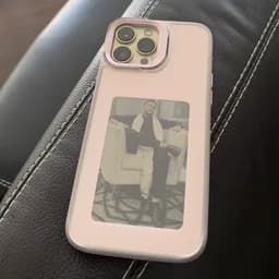 Gia's Blush case lying on a leather couch, a photo of a man on its panel