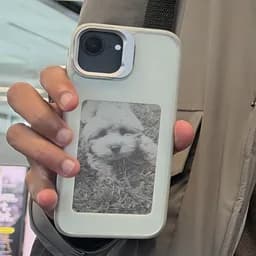 Manoj holding his Light case, a photo of a dog on its panel