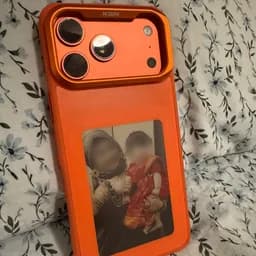 Tithi's Amber Canvas Pro on a floral bedspread, a photo of a woman holding a little girl on its panel, their faces blurred